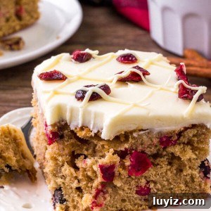 Festive Cranberry Christmas Cake Recipe for Holiday Parties 6 This cranberry Christmas cake is like a Cranberry Bliss Bar - but extra moist with tons of white chocolate cream cheese frosting.