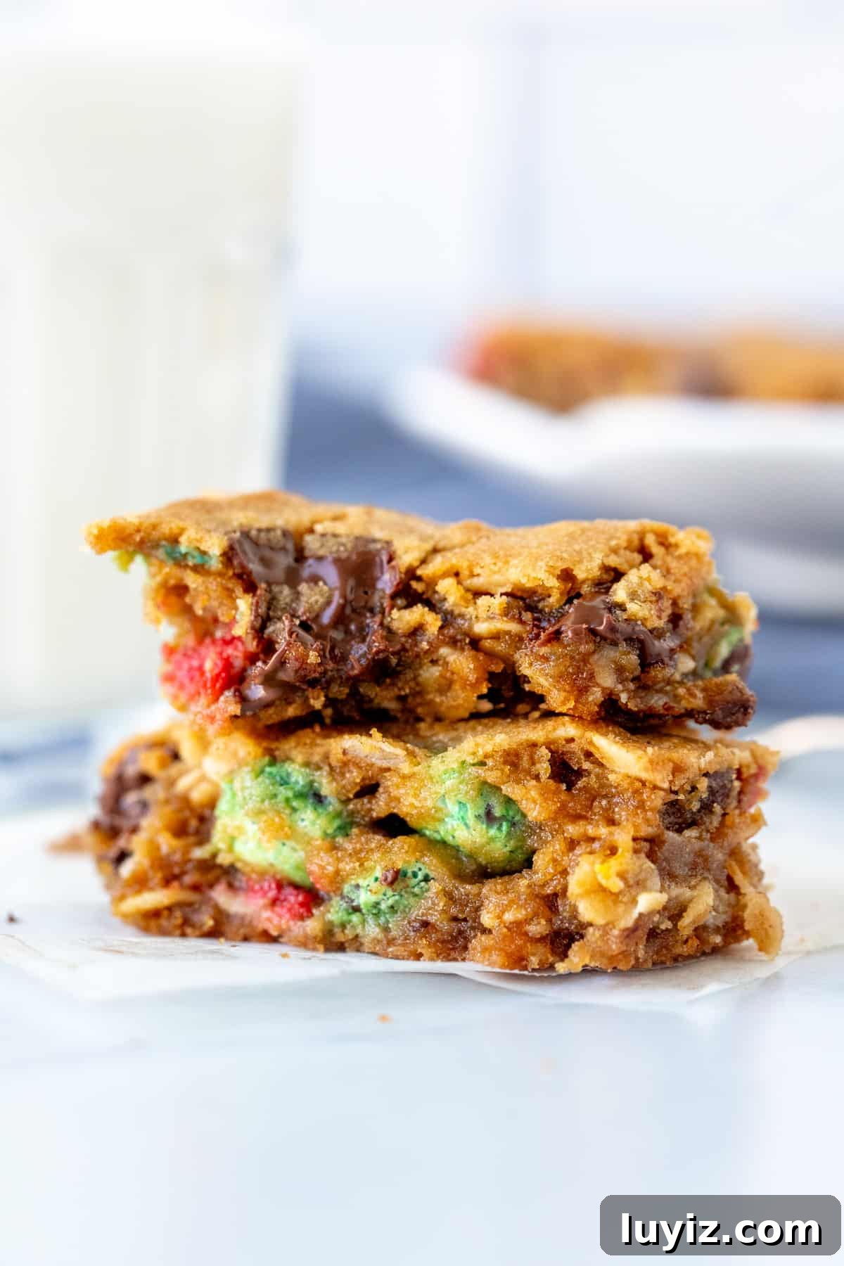 Chewy Monster Cookie Bars Recipe with M&Ms and Oats 7 Monster cookie bar with chocolate chips and M&Ms, broken in half