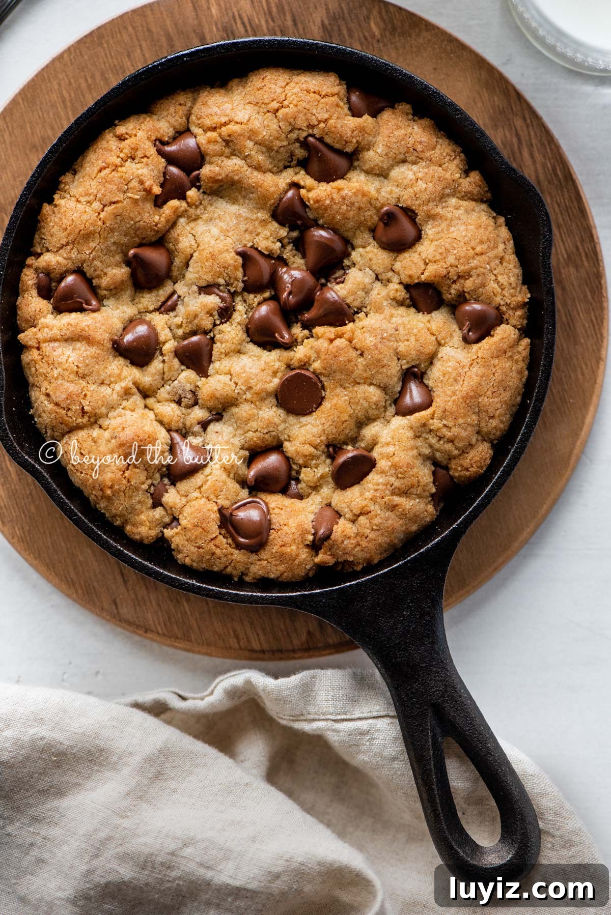 Brown Butter Chocolate Chip Skillet Cookie Recipe 3 Just baked chocolate chip skillet cookies on light gray background with cloth napkin