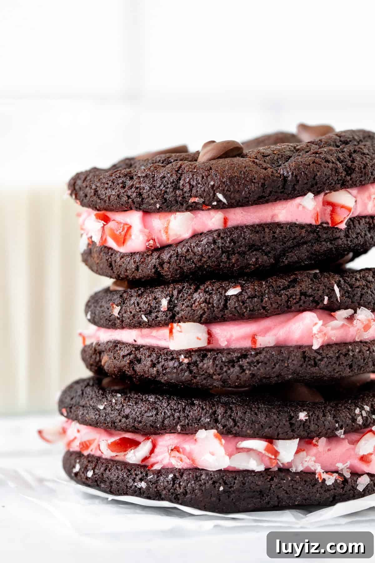 Chocolate Peppermint Sandwich Cookies Recipe 4 Three cookie sandwiches, made with double chocolate cookies and pink peppermint frosting stacked on top of each other
