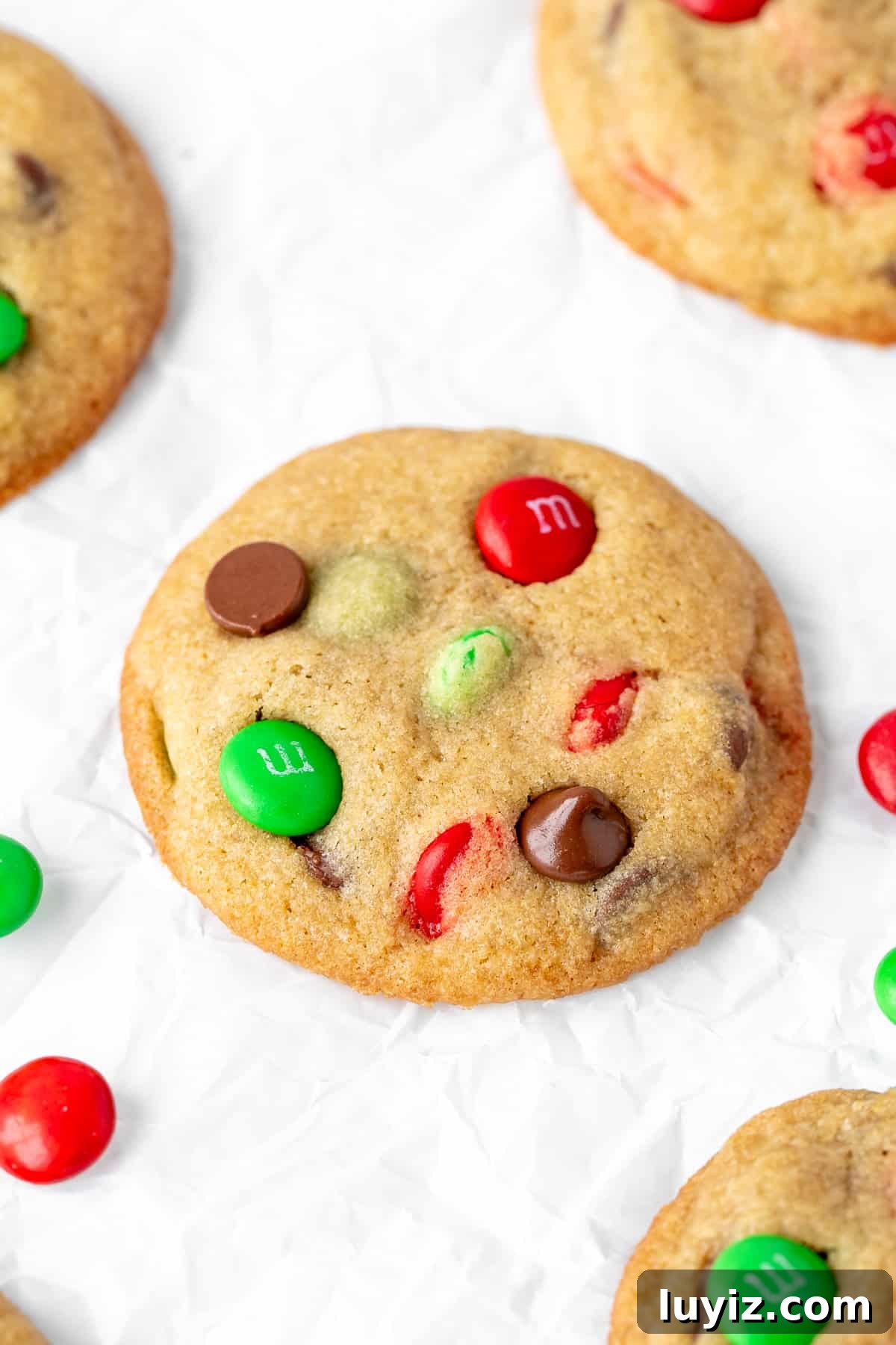 Christmas M&M Cookies: Festive Candy-Stuffed Cookie Recipe 2 Christmas M&M cookies on baking paper