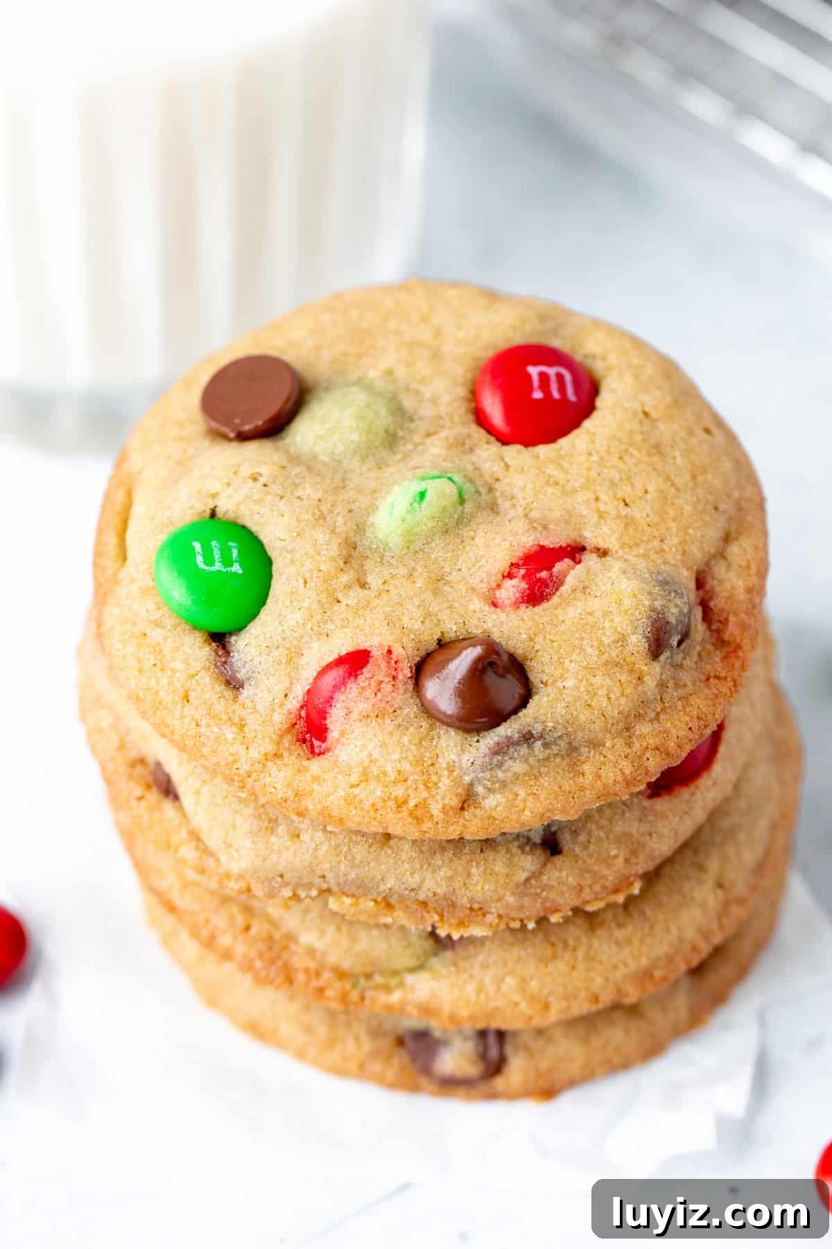 Christmas M&M Cookies: Festive Candy-Stuffed Cookie Recipe 3 Stack of cookies filled with chocolate chips and Christmas M&Ms