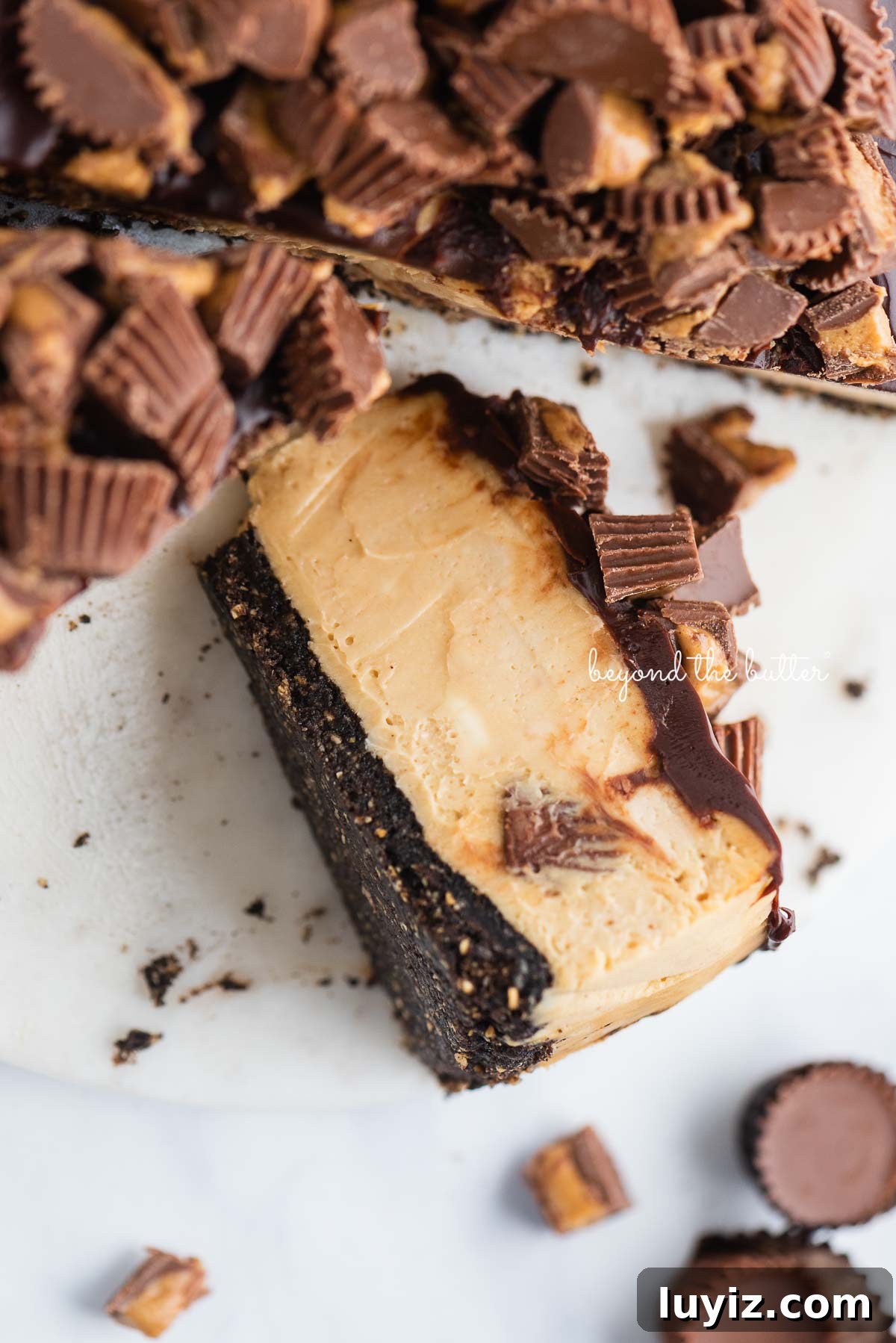 Reese’s Peanut Butter Cup Cheesecake Recipe: Decadent No-Bake Dessert 9 Slice of peanut butter cheesecake with peanut butter cups on its side.