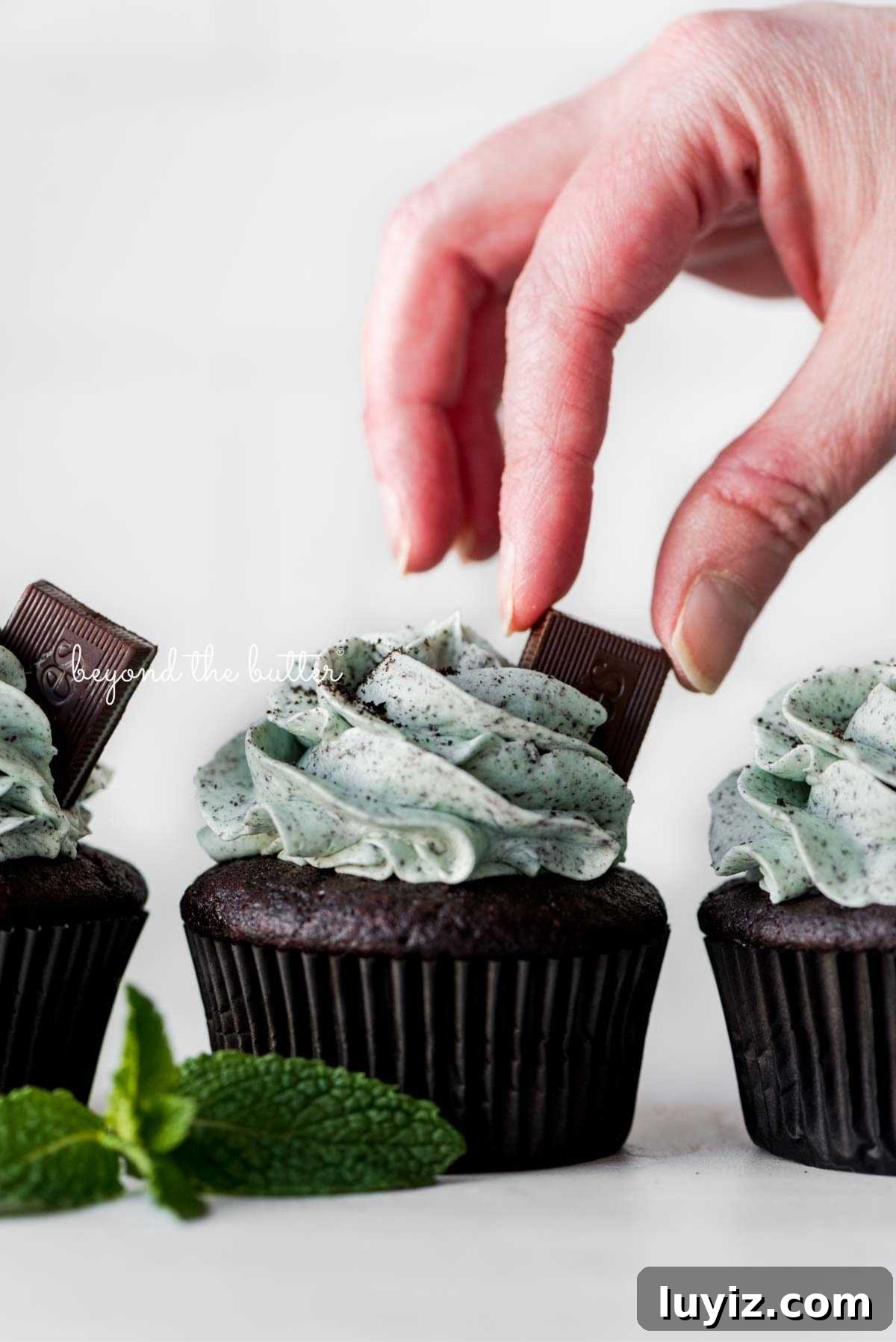 Mint Chocolate Cupcake Recipe: Moist Chocolate Cakes with Minty Frosting 17 Placing an Andes mint on top of a mint chocolate cupcake for garnish.