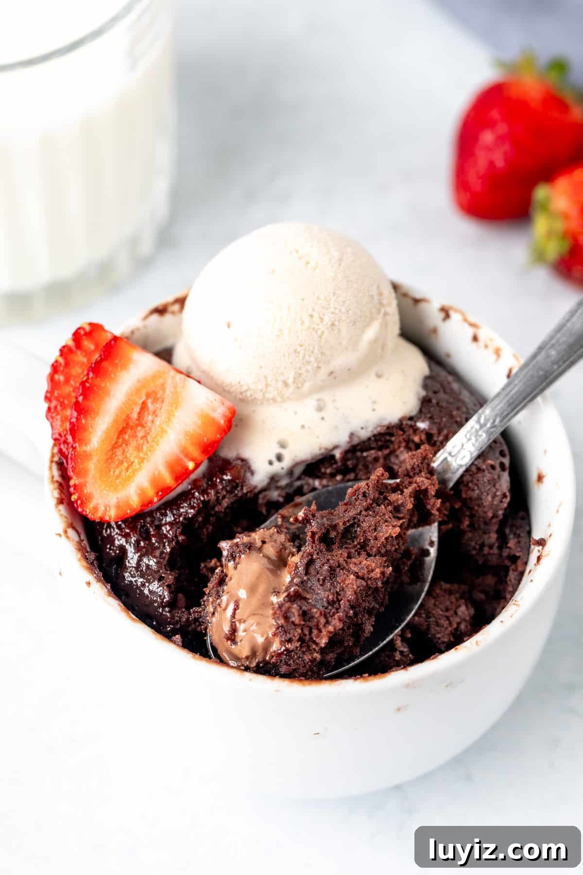 Quick Nutella Mug Cake Recipe Ready in Minutes 2 Nutella mug cake, with a spoonful taken out.