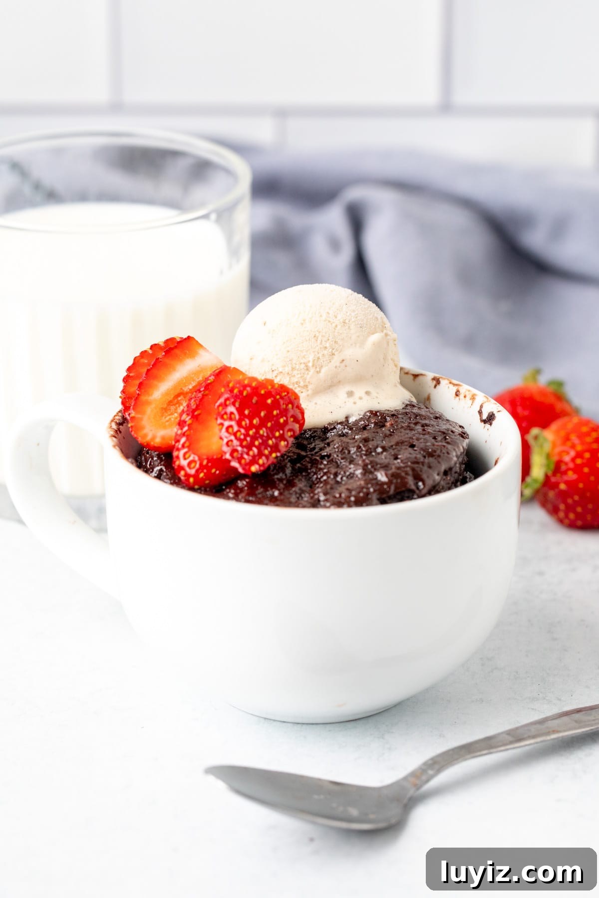 Quick Nutella Mug Cake Recipe Ready in Minutes 6 Single serving Nutella cake in a mug, topped with ice cream and berries with glass of milk