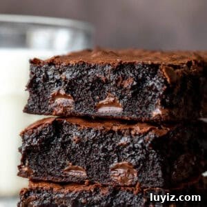 Chewy Fudgy Homemade Brownies Made with Cocoa 11 Stack of three chocolate chip brownies with glass of milk