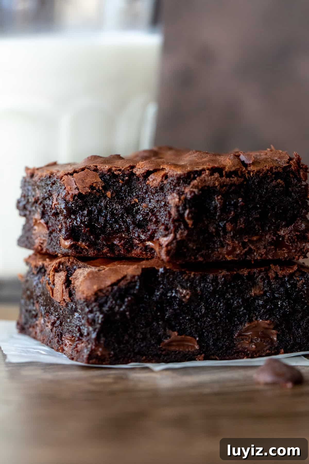 Chewy Fudgy Homemade Brownies Made with Cocoa 9 Two gooey chocolate chip brownies on top of each other with glass of milk