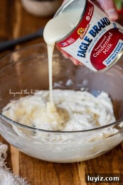 No-Bake Chocolate Strawberry Pie Recipe for Summer Parties 7 Pouring Eagle Brand® sweetened condensed milk into the mixing bowl with cream cheese | All images © Beyond the Butter®