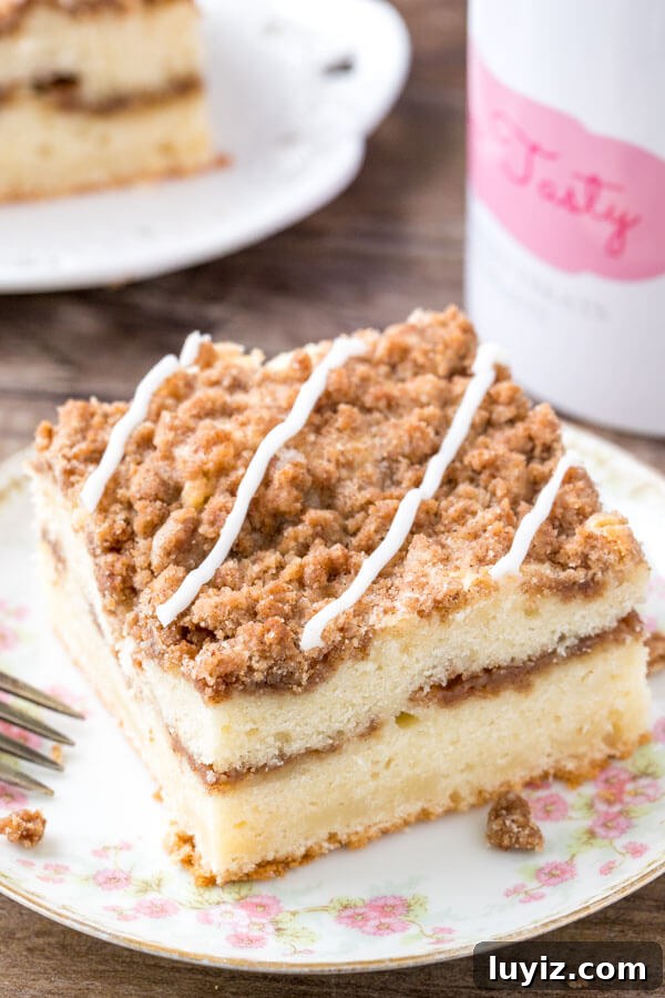 Cinnamon Streusel Coffee Cake Recipe with Moist Vanilla Crumb Topping 5 A slice of cinnamon coffee cake with cinnamon filling and brown sugar streusel topping.