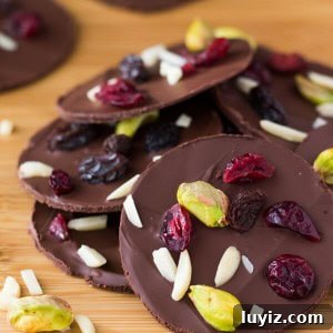 Dark Chocolate Fruit and Nut Clusters: Homemade No-Bake Treats 4 Dark Chocolate Fruit & Nut Clusters with pistachios, almonds, dried cranberries and raisins. Ready in minutes and so pretty, they make a great gift too! www.justsotasty.com