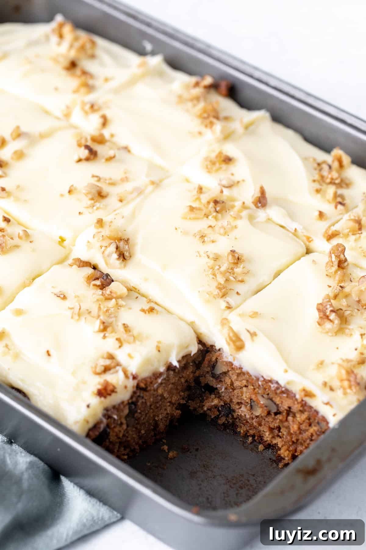 Ultra-Moist Carrot Cake Recipe with Cream Cheese Frosting 6 9x13 inch pan of carrot cake with cream cheese frosting, sliced into squares