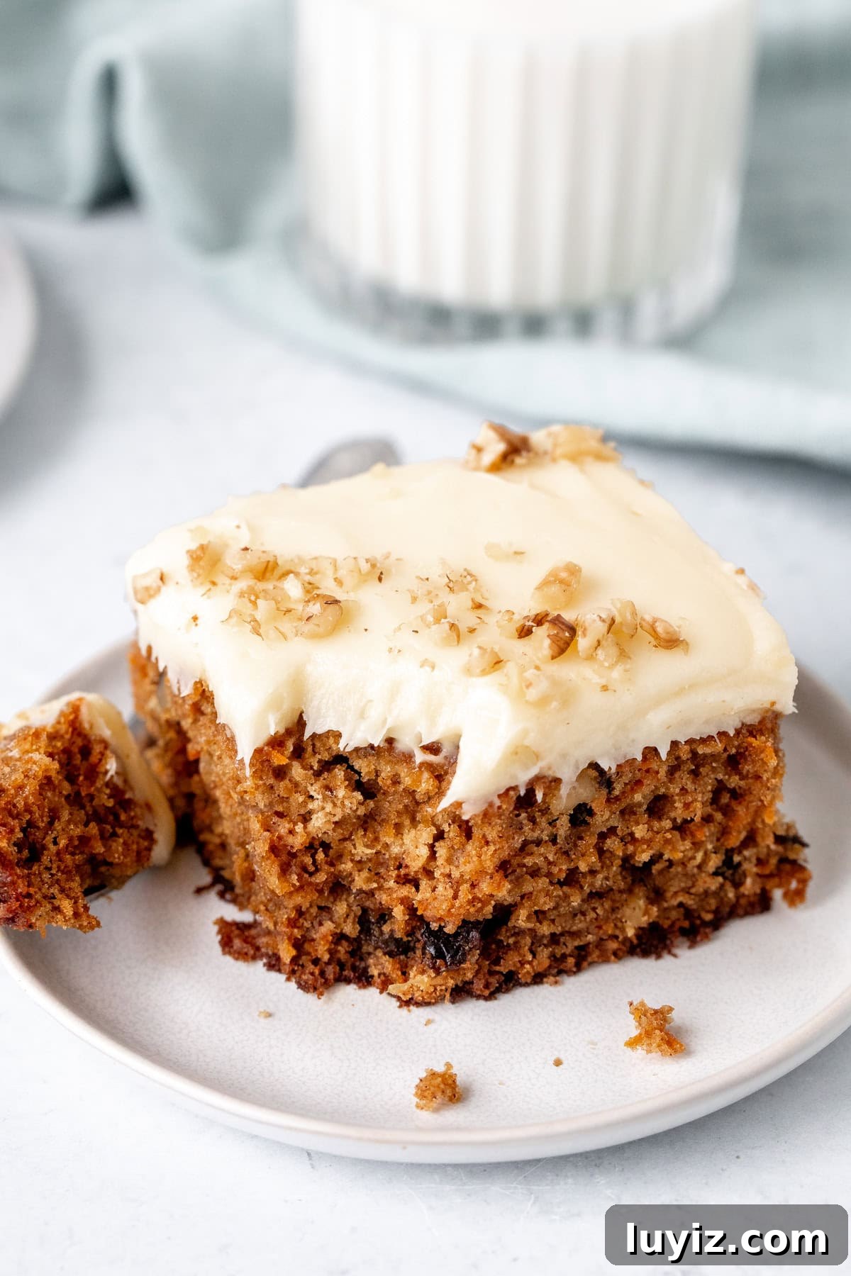 Ultra-Moist Carrot Cake Recipe with Cream Cheese Frosting 7 Slice of carrot cake sheet cake with bite taken out