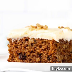 Ultra-Moist Carrot Cake Recipe with Cream Cheese Frosting 8 Piece of carrot cake with a thick layer of cream cheese icing on top