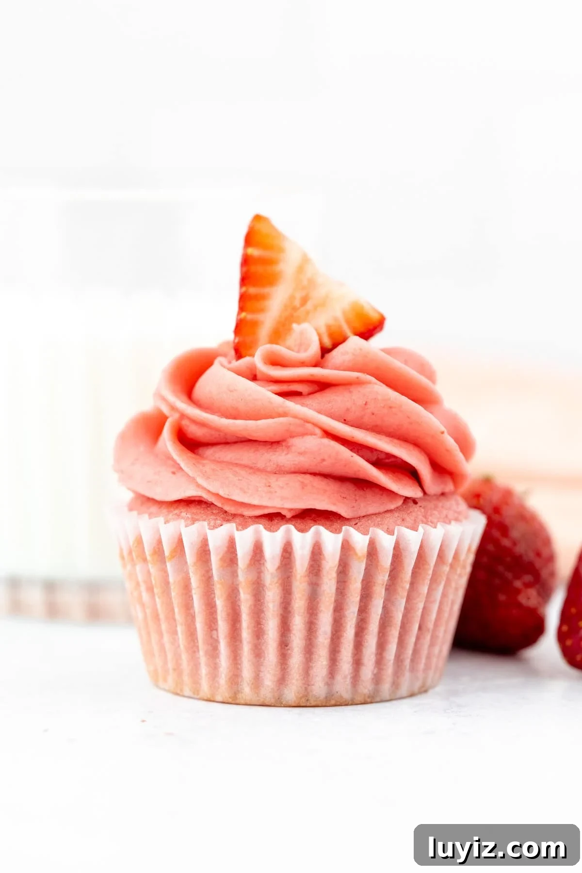 Moist Strawberry Cupcakes with Fresh Strawberry Frosting 12 Strawberry cupcake with a glass of milk