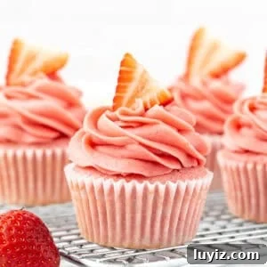 Moist Strawberry Cupcakes with Fresh Strawberry Frosting 13 strawberry cupcakes with strawberry frosting on a wire cooling rack
