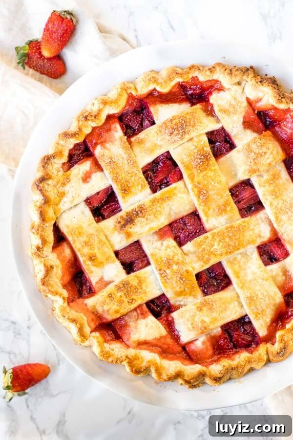 Classic Fresh Strawberry Pie Recipe for Summer Gatherings 4 Baked Strawberry Pie with lattice pie crust on top.