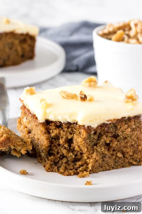 Moist Zucchini Cake Recipe with Cinnamon and Walnuts 2 This moist, tender zucchini cake is filled with spices and topped with cream cheese frosting.