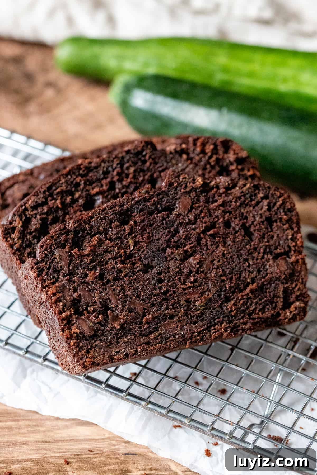 Moist Chocolate Zucchini Bread Recipe with Dark Cocoa 6 Slices of moist chocolate zucchini bread on wire cooling rack