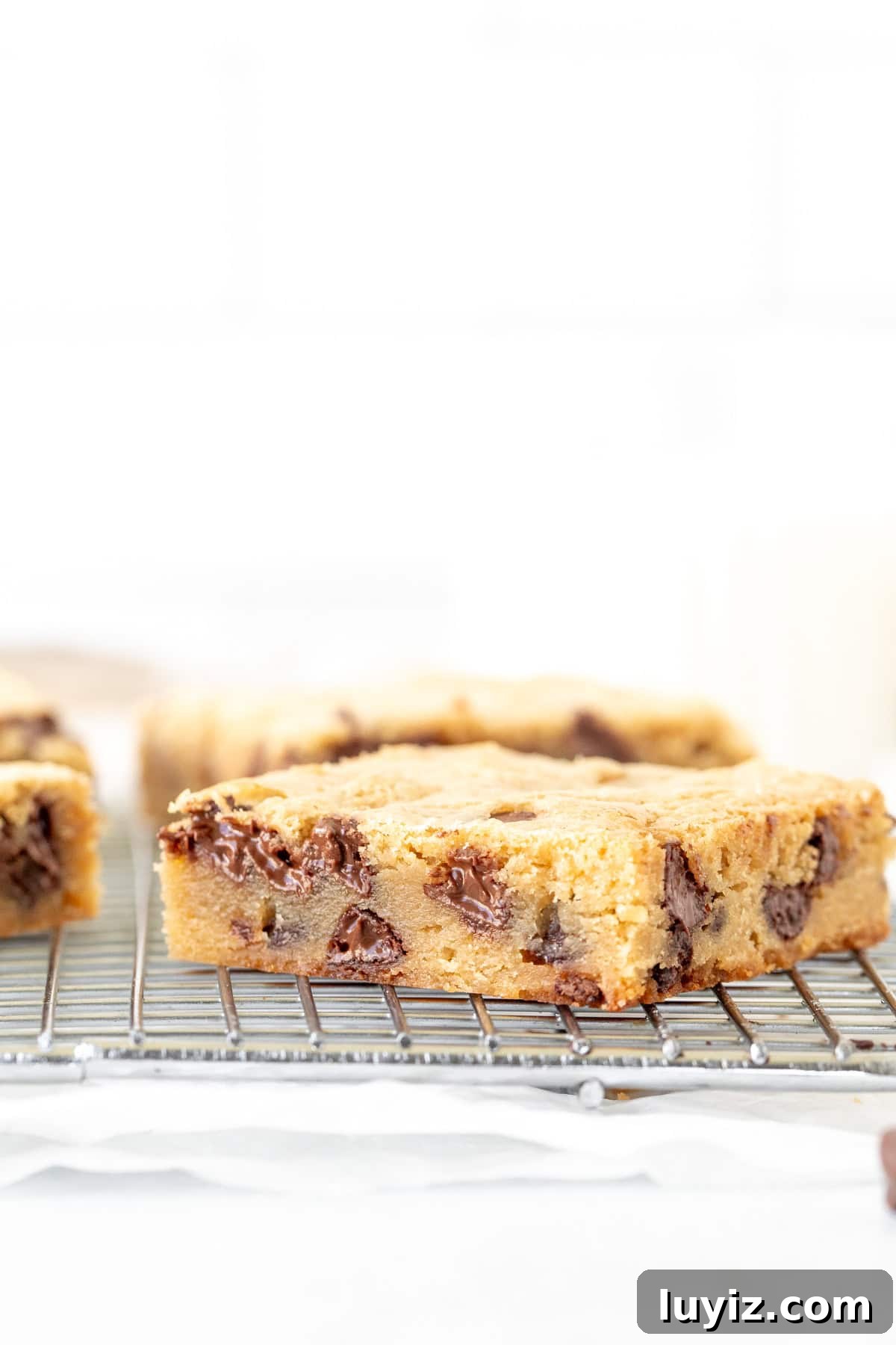 Chewy Vanilla Blondies with Salted Caramel Swirl 3 Chocolate chip blondie on cooling rack