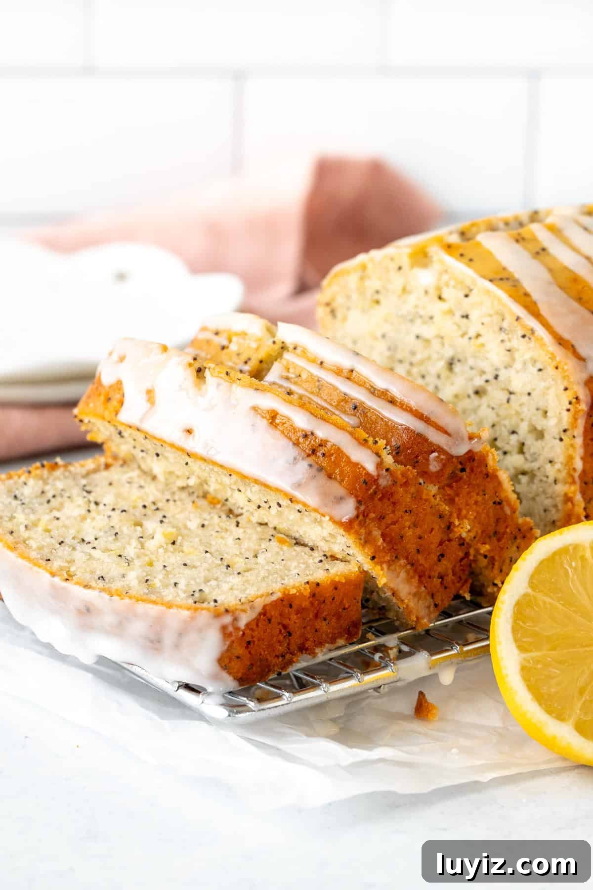 Lemon Poppy Seed Quick Bread Recipe for Moist Loaves 3 3 slices of lemon poppy seed bread with lemon glaze on a cooling rack
