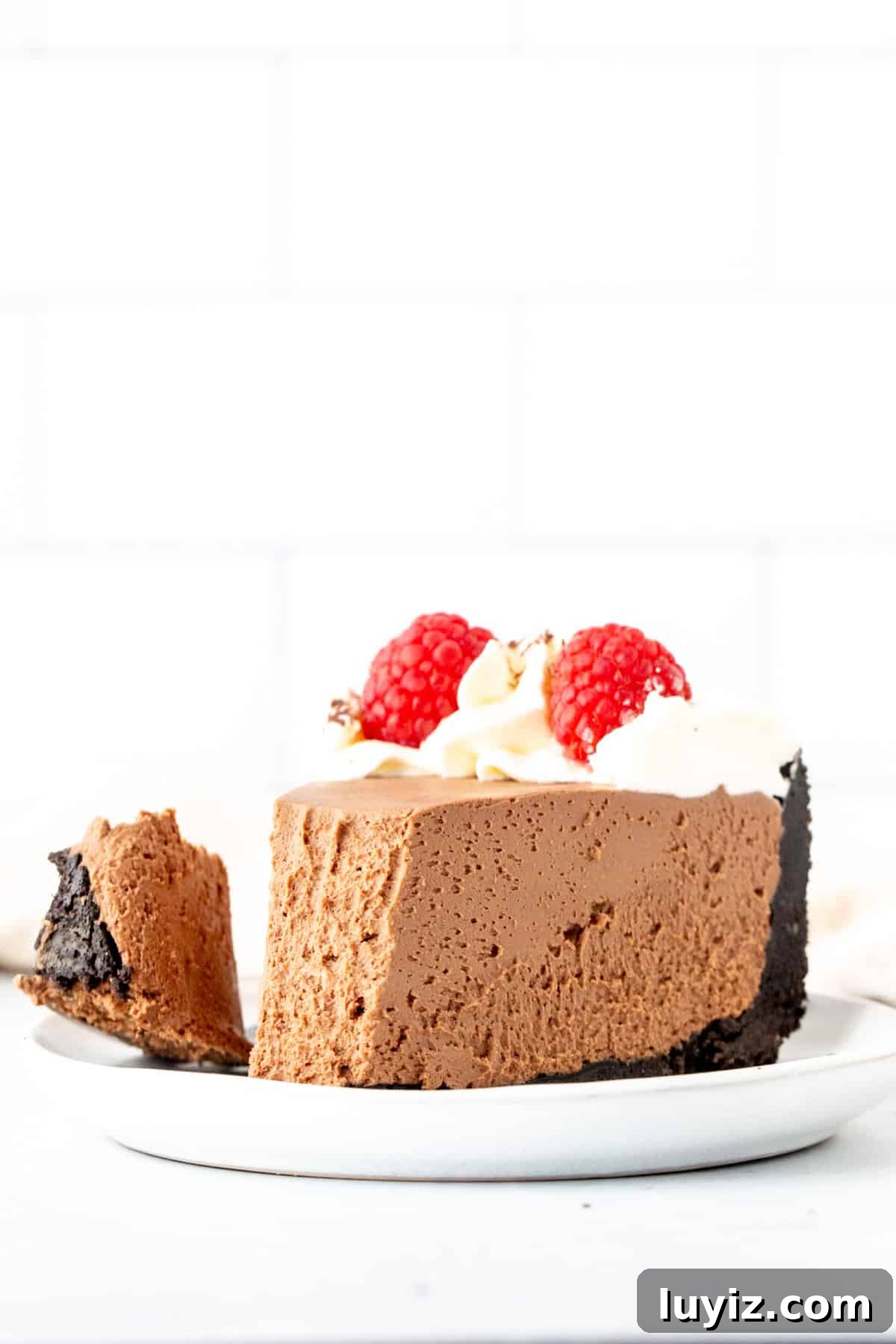 Creamy No-Bake Chocolate Cheesecake Recipe 10 Slice of chocolate cheesecake with Oreo crust with bite taken out