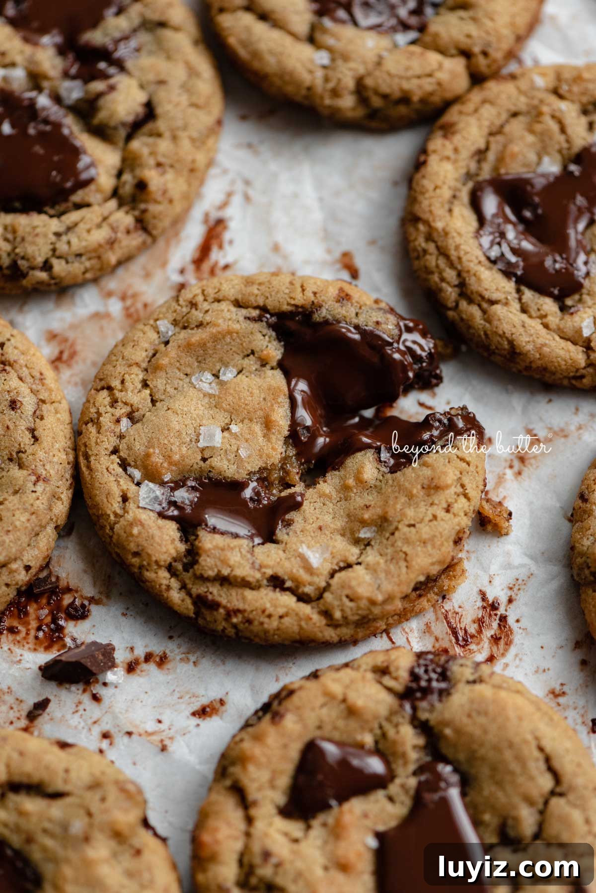 Gluten-Free Peanut Butter Chocolate Chunk Cookies (Small Batch) 2 Small batch gluten-free peanut butter chocolate chunk cookies on a parchment paper lined baking sheet | © Beyond the Butter®