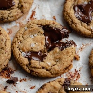 Gluten-Free Peanut Butter Chocolate Chunk Cookies (Small Batch) 9 Small batch gluten-free peanut butter chocolate chunk cookies on a parchment paper lined baking sheet.