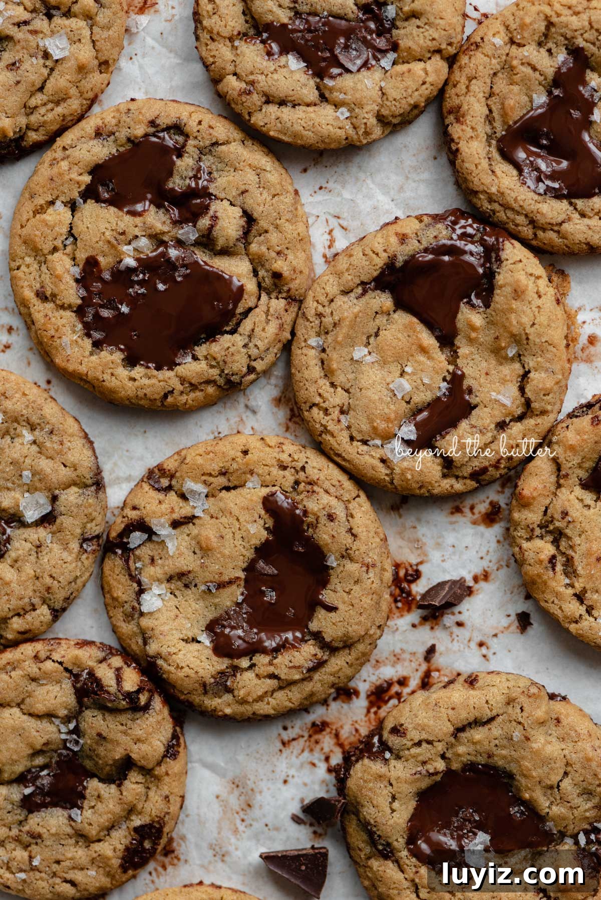 Gluten-Free Peanut Butter Chocolate Chunk Cookies (Small Batch) 3 Small batch gluten-free peanut butter chocolate chunk cookies on a parchment paper lined baking sheet | © Beyond the Butter®