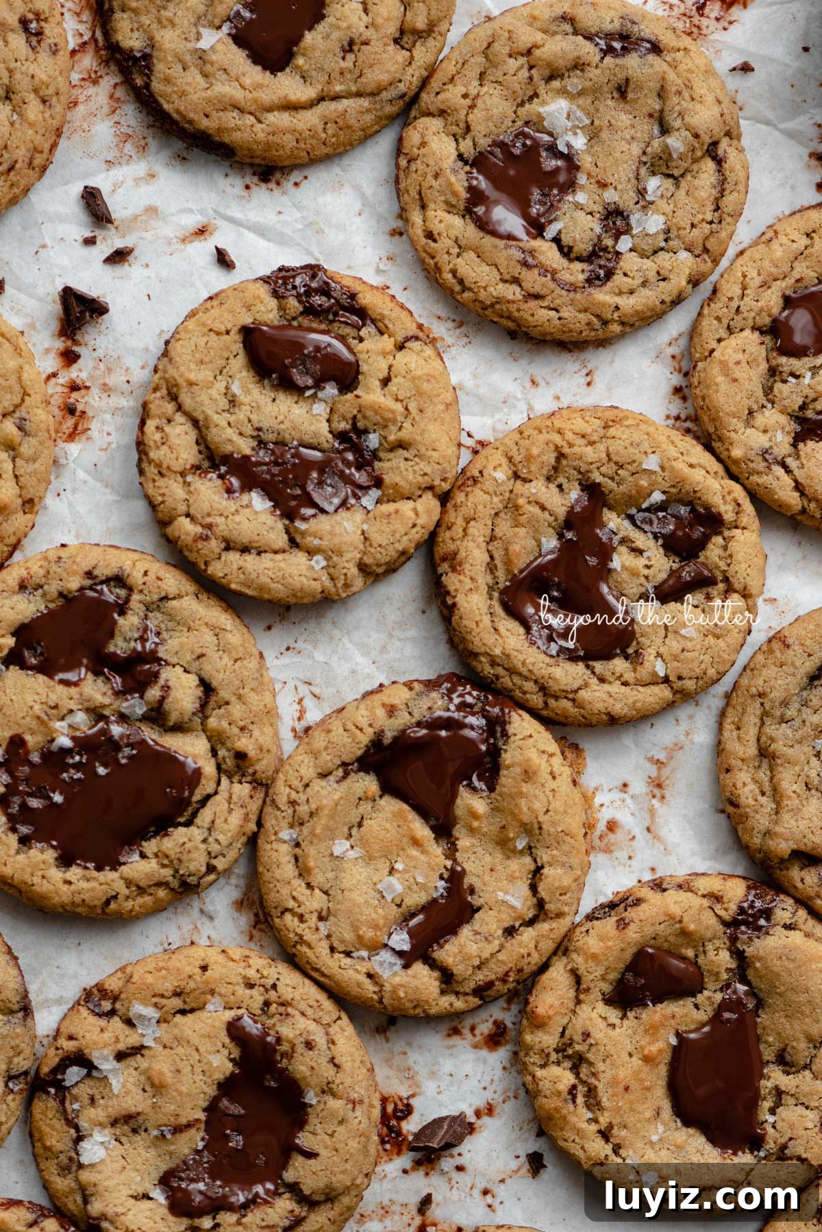 Gluten-Free Peanut Butter Chocolate Chunk Cookies (Small Batch) 4 Small batch gluten-free peanut butter chocolate chunk cookies on a parchment paper lined baking sheet | © Beyond the Butter®