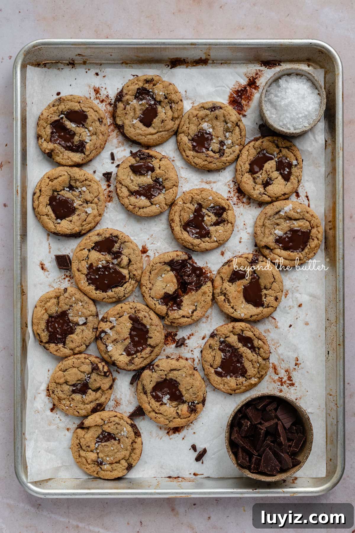 Gluten-Free Peanut Butter Chocolate Chunk Cookies (Small Batch) 6 Small batch gluten-free peanut butter chocolate chunk cookies on a parchment paper lined baking sheet | © Beyond the Butter®