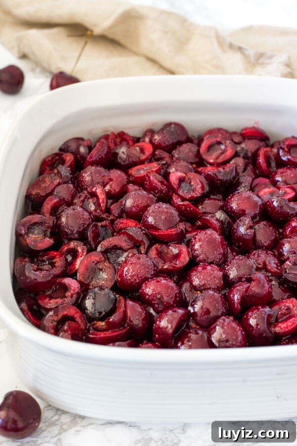Classic Cherry Cobbler Recipe: Sweet Baked Cherry Dessert 3 Cherry layer for making cherry cobbler in the pan before the biscuit topping layer as been added on top.