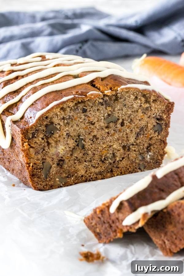 Moist Banana Carrot Quick Bread Recipe 4 Banana carrot bread after slices have been cut to show the moist, tender crumb, grated carrots and walnuts.