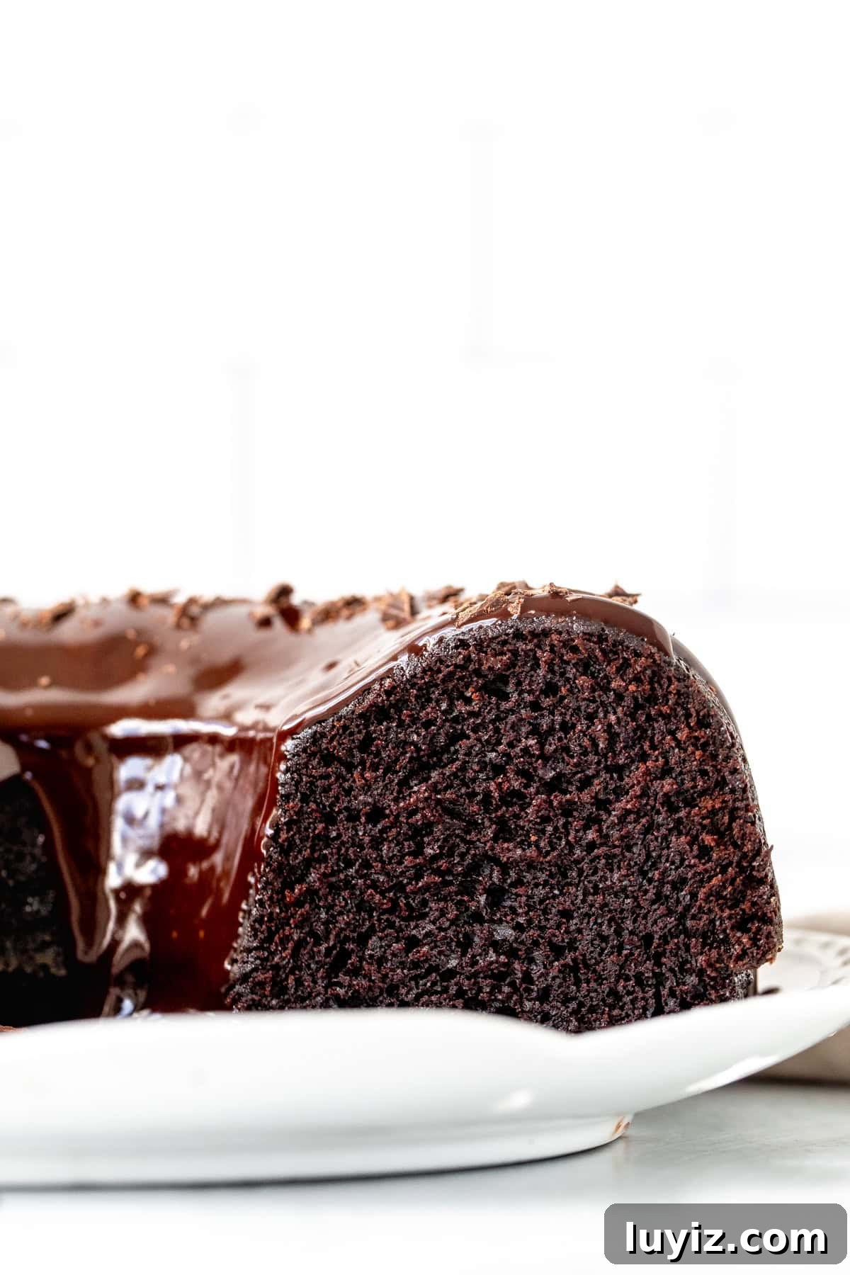 Decadent Chocolate Bundt Cake Recipe for Moist, Rich Dessert 3 chocolate bundt cake topped with ganache with slices cut