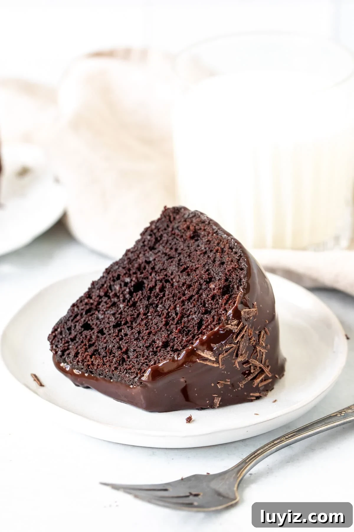 Decadent Chocolate Bundt Cake Recipe for Moist, Rich Dessert 7 Slice of chocolate bundt cake with milk