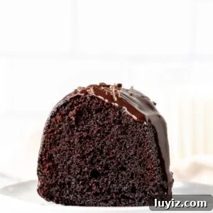 Decadent Chocolate Bundt Cake Recipe for Moist, Rich Dessert 8 Slice of fudgy chocolate bundt cake drizzled with ganache