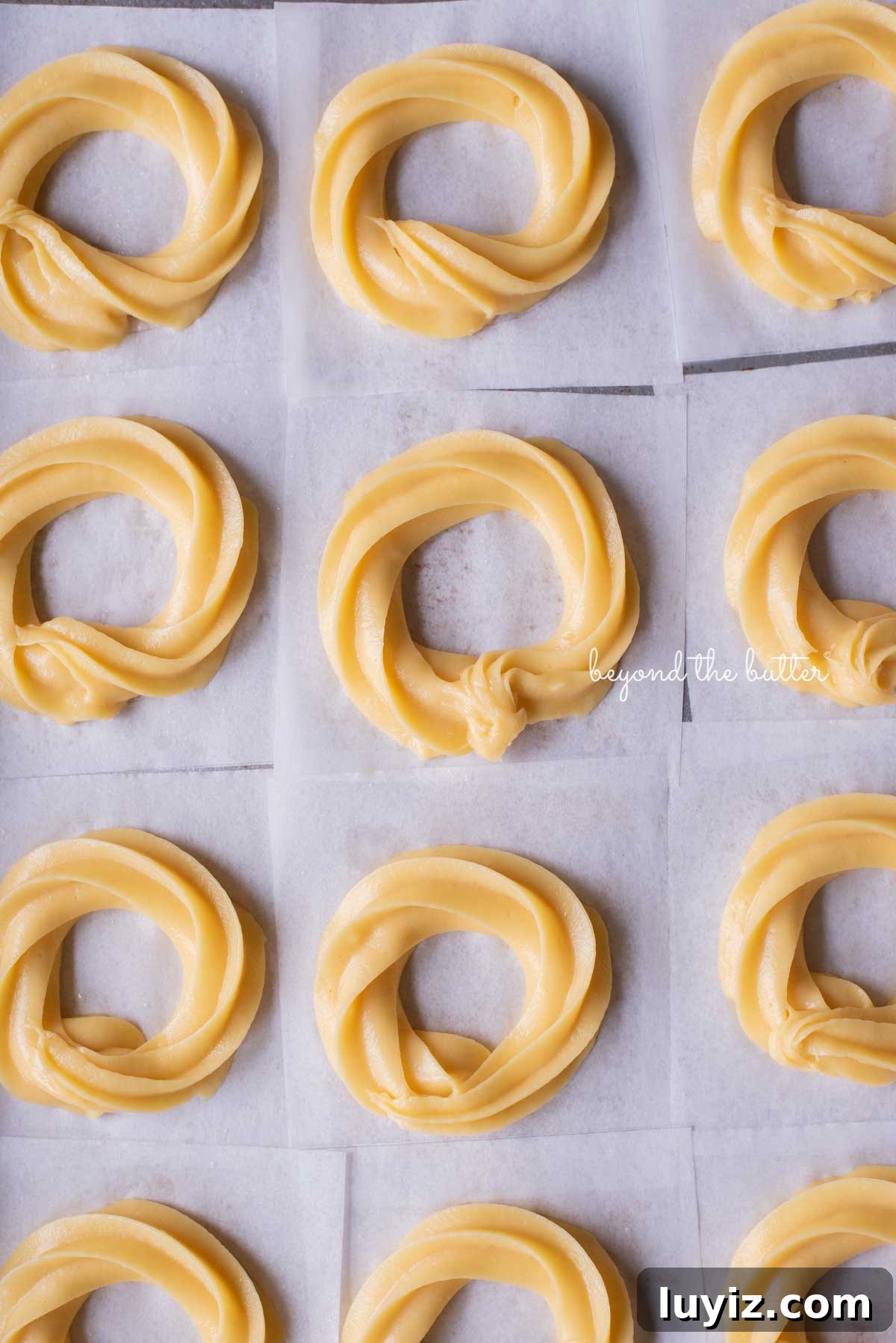 Strawberry-Glazed French Crullers Recipe for Homemade Pastries 5 Piped chouz pastry rings ready for frying | © Beyond the Butter®