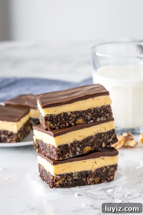 How to Make Classic Nanaimo Bars: No-Bake Canadian Dessert Recipe 3 A stack of 3 traditional Nanaimo bars.