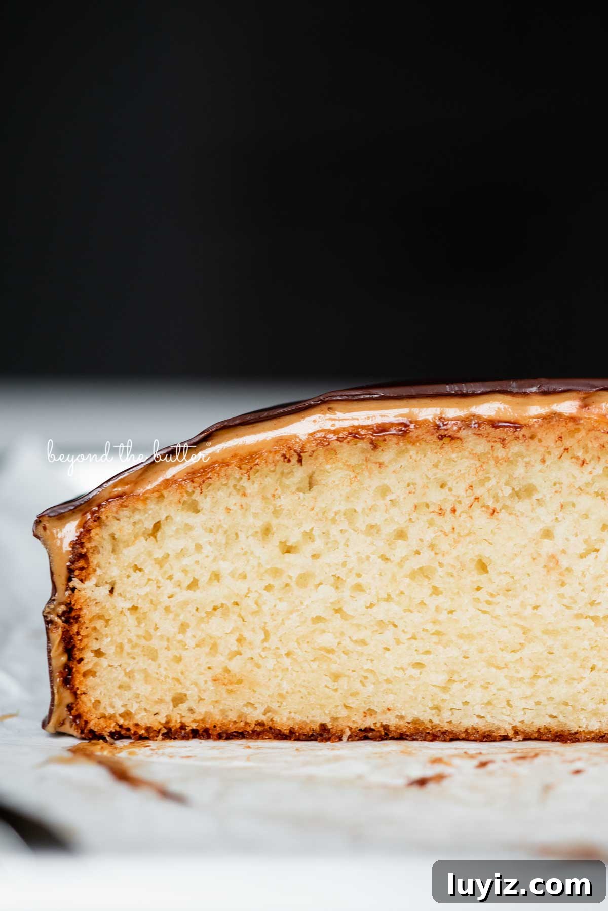 Mini Chocolate Peanut Butter Tandy Cake Recipe 4 Open sliced image of chocolate peanut butter tandy kake on a parchment paper lined baking sheet | © Beyond the Butter®