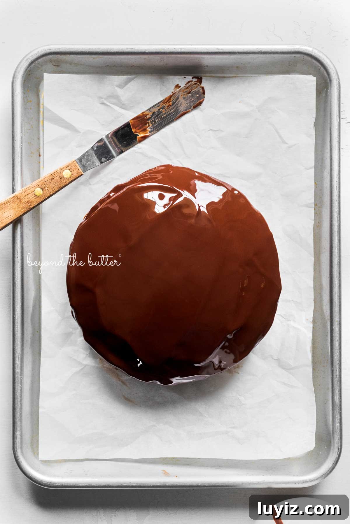 Mini Chocolate Peanut Butter Tandy Cake Recipe 10 Small chocolate peanut butter tandy kake just covered in melted chocolate on a white parchment paper lined baking sheet | © Beyond the Butter®