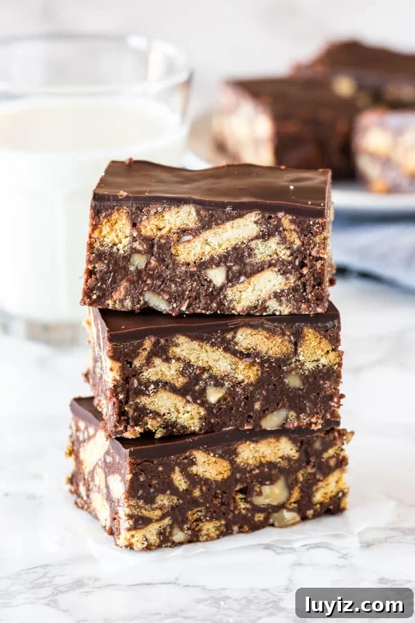 No-Bake Chocolate Hedgehog Slice Recipe for Crowd-Pleasing Treats 3 A stack of 3 pieces of hedgehog slice taken from the side to show the texture of the slice.