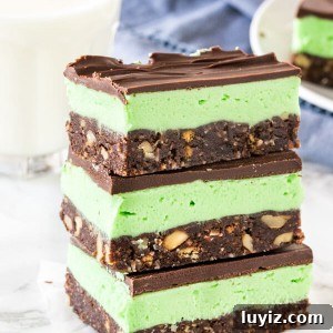 Mint Chocolate Nanaimo Bars Recipe — No-Bake Layered Treats 5 A stack of 3 mint Nanaimo bars shot from the side to see the 3 layers.