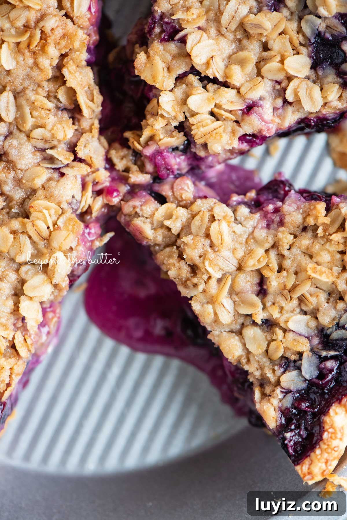 Blueberry Crumble Pie Recipe with Crunchy Oat Topping 5 Slices of blueberry crumble pie in pie plate with scoop of ice cream in the center