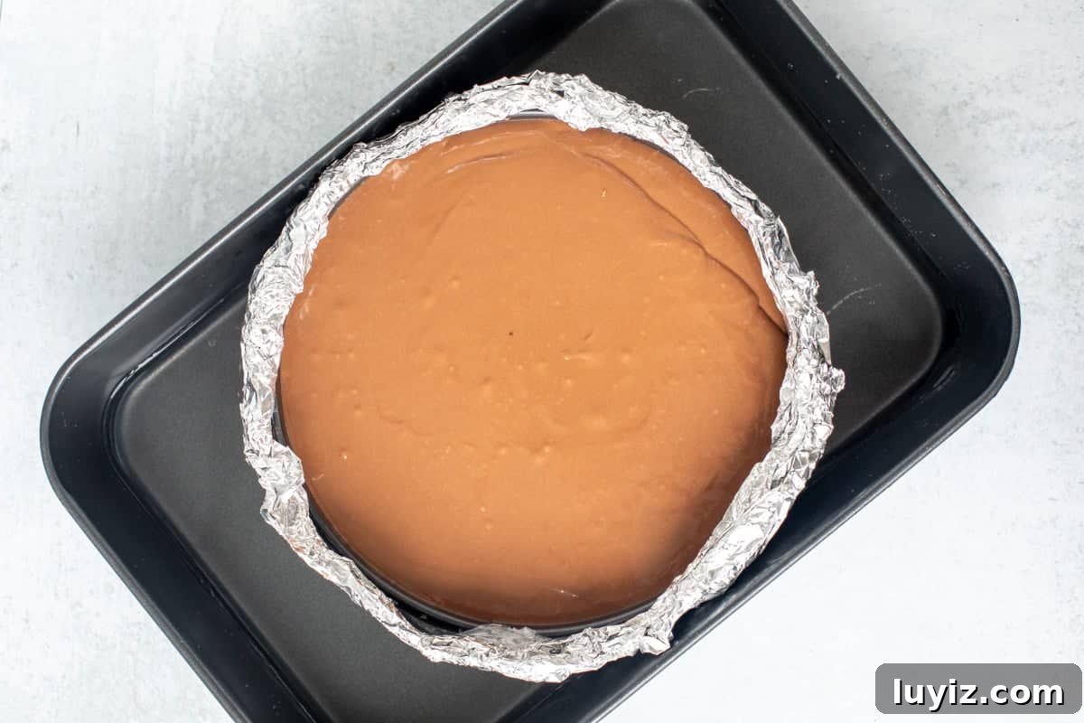 Decadent Nutella Cheesecake with Oreo Cookie Crust 7 Springform pan of unbaked Nutella cheesecake in a large roasting pan