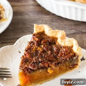 Classic Southern Pecan Pie Recipe with Buttery Pecan Topping 7 A slice of pecan pie