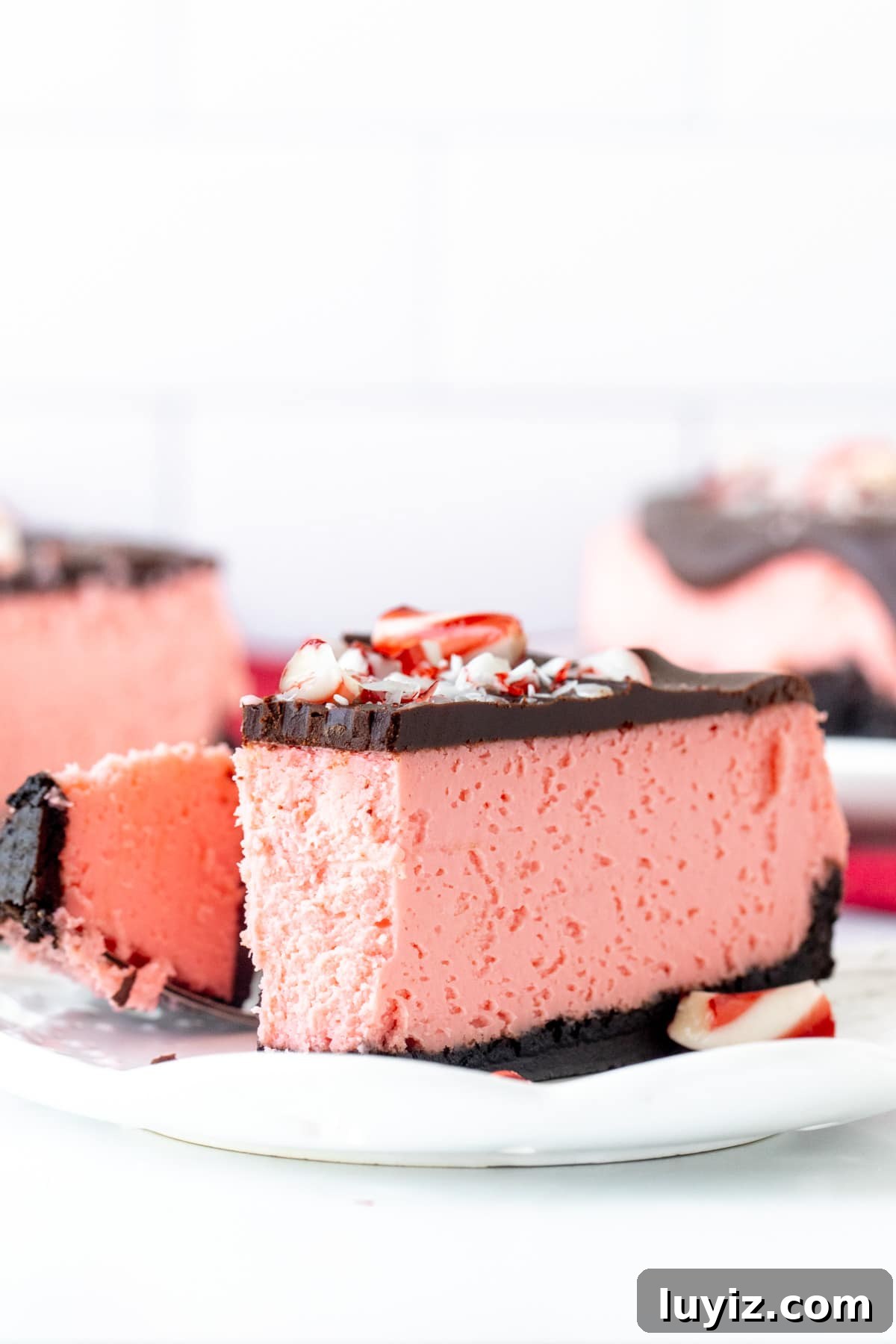 Peppermint Cheesecake Recipe: Creamy Mint Holiday Dessert 5 Slice of peppermint cheesecake on a plate with a bite taken out