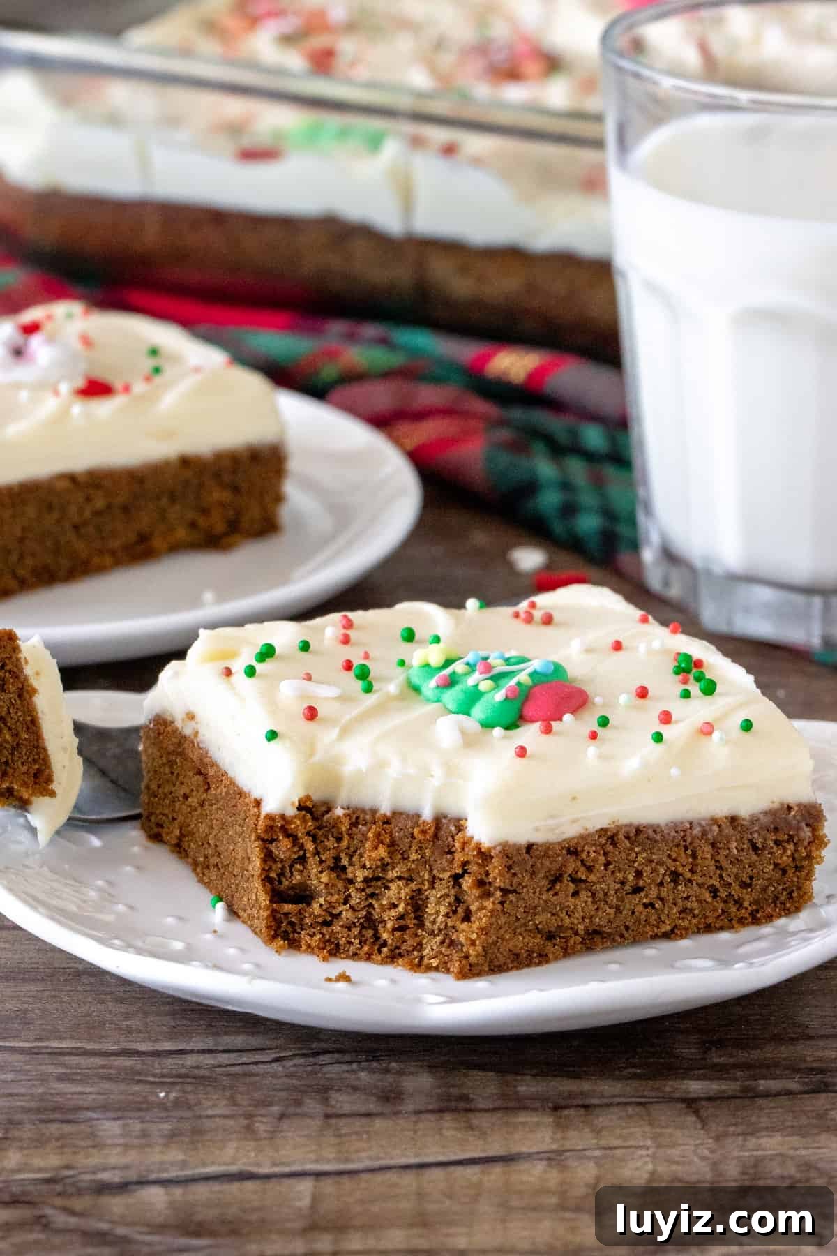Chewy Gingerbread Cookie Bars with Spiced Molasses Glaze 2 Gingerbread cookie bar on a plate with a bite taken out.