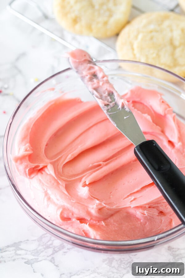 A bowl of pink sugar cookie frosting