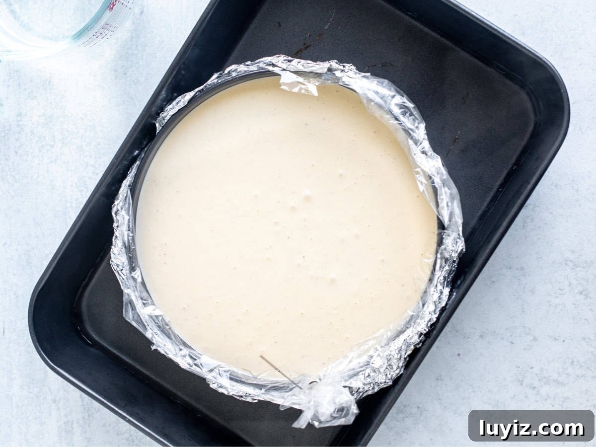 Creamy Eggnog Cheesecake Recipe for Festive Holidays 7 unbaked eggnog cheesecake in a water bath