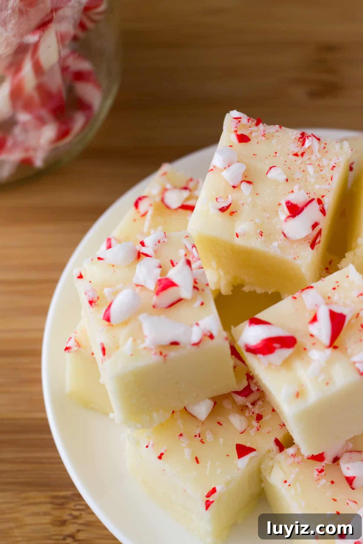 Creamy White Chocolate Peppermint Fudge. So delicious & perfect for the holidays - it makes a decadent, delicious gift! www.justsotasty.com